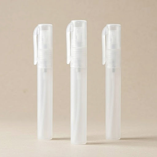 Three clear plastic bottles with caps on a beige background